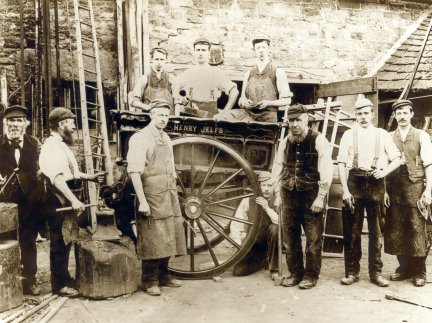 Frederick Stoke's wheelwright business in about 1880. Frederick is in front of the wheel. 